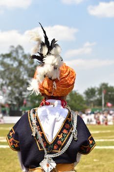 Khasi dancer in traditional attire with feathers at a cultural event in Shillong.